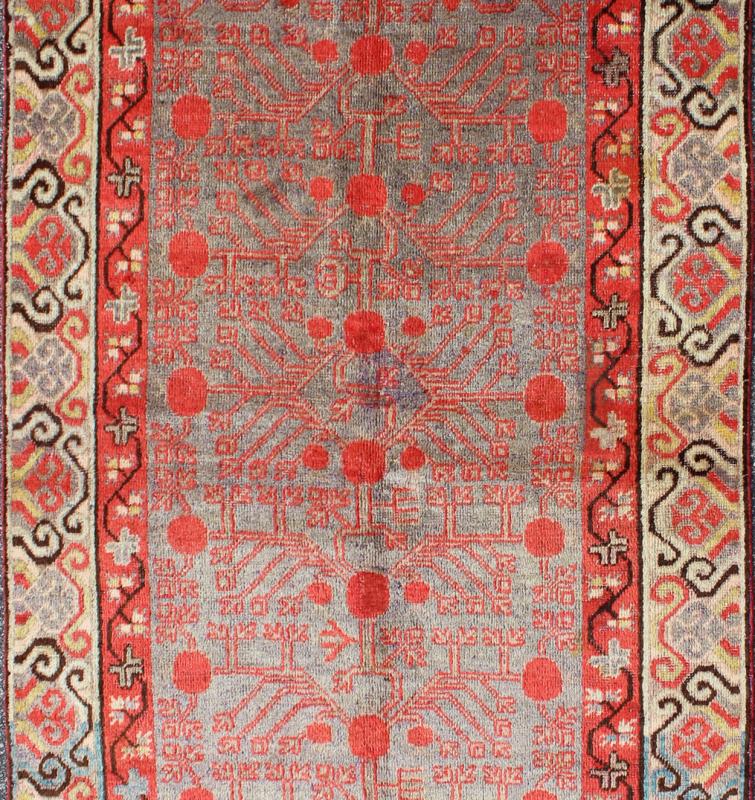 Intricate Vintage Khotan Rug with Sub - Geometric Design in Reds and Light Blue. Measures: 3'10'' x 8'1''. This unique antique Khotan rug is a spectacular testament to the complexity of Turkestan design. The red and light blue of the central fi... - Keivan Woven ArtsMP - 1610 - 157641 - 7877Rug