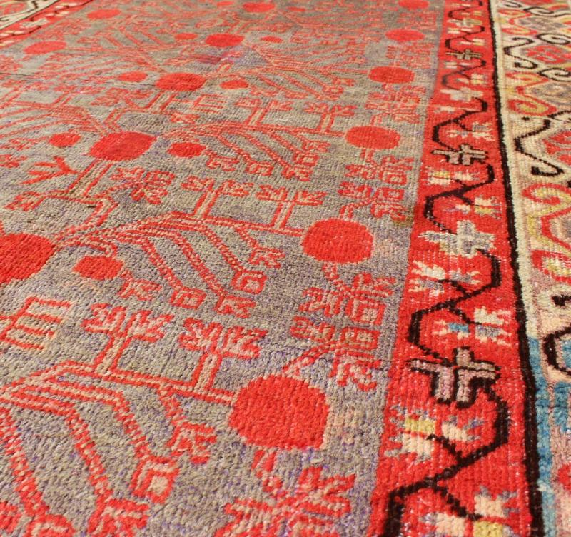 Intricate Vintage Khotan Rug with Sub - Geometric Design in Reds and Light Blue. Measures: 3'10'' x 8'1''. This unique antique Khotan rug is a spectacular testament to the complexity of Turkestan design. The red and light blue of the central fi... - Keivan Woven ArtsMP - 1610 - 157641 - 7877Rug