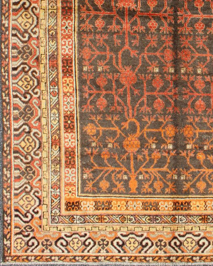Antique Khotan Rug An antique, early 20th century, Central Asian Khotan rug with traditional all - over pomegranate pattern on a charcoal field surrounded by multiple complementary floral borders of gold and orange. Measures: 5'7 x 8'11. - Keivan Woven ArtsMP - 1610 - 157652 - 7881Rug