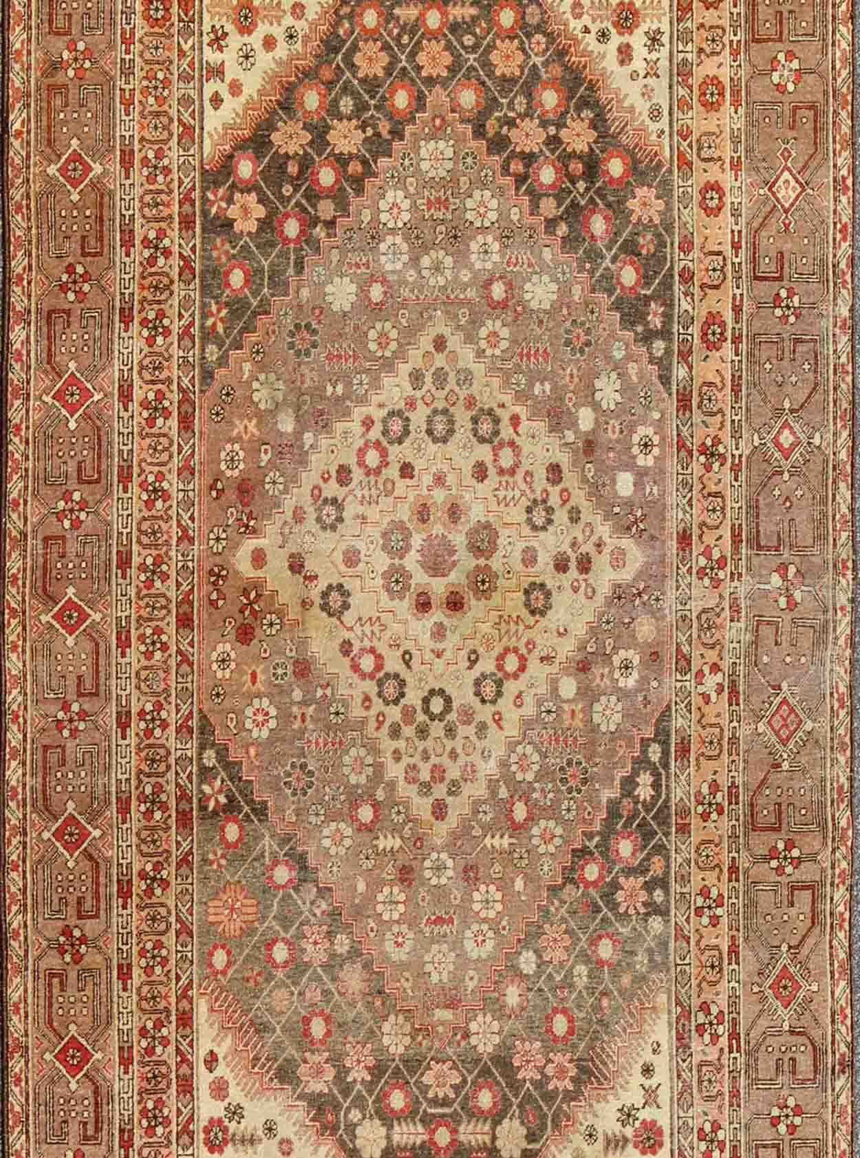 Antique Khotan Medallion Rug in Neutrals and Blush with Floral Motifs All - Over Measures: 6'4 x 11'6 This beautiful Khotan rug, from early 20th century Turkestan features layered medallions in geometric and diamond shapes. The field and ... - Keivan Woven ArtsMP - 252 - 2125Rug