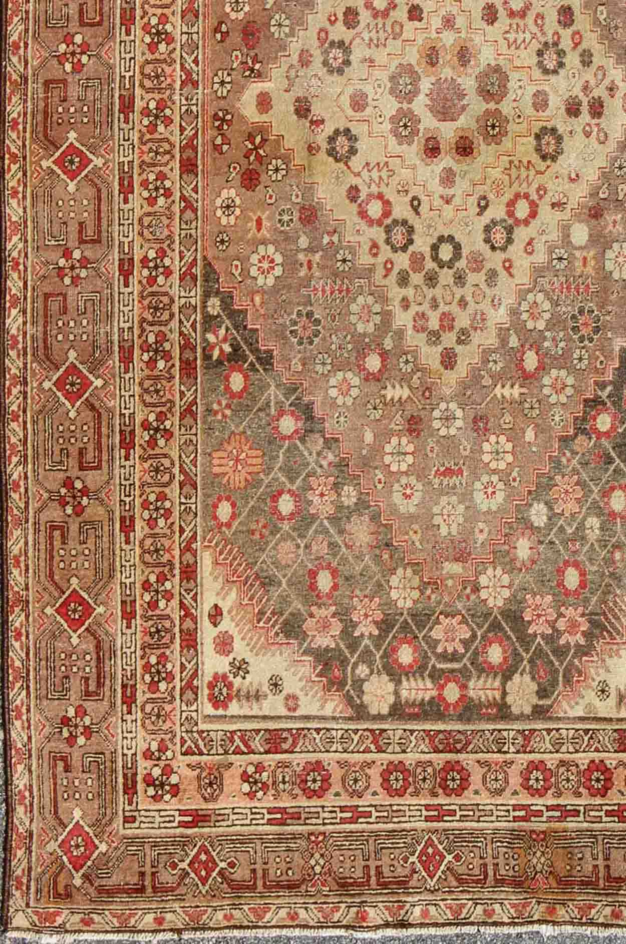Antique Khotan Medallion Rug in Neutrals and Blush with Floral Motifs All - Over Measures: 6'4 x 11'6 This beautiful Khotan rug, from early 20th century Turkestan features layered medallions in geometric and diamond shapes. The field and ... - Keivan Woven ArtsMP - 252 - 2125Rug