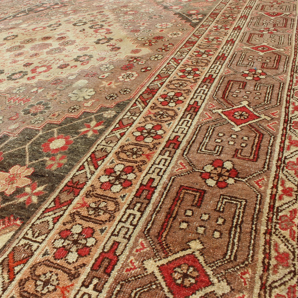 Antique Khotan Medallion Rug in Neutrals and Blush with Floral Motifs All - Over Measures: 6'4 x 11'6 This beautiful Khotan rug, from early 20th century Turkestan features layered medallions in geometric and diamond shapes. The field and ... - Keivan Woven ArtsMP - 252 - 2125