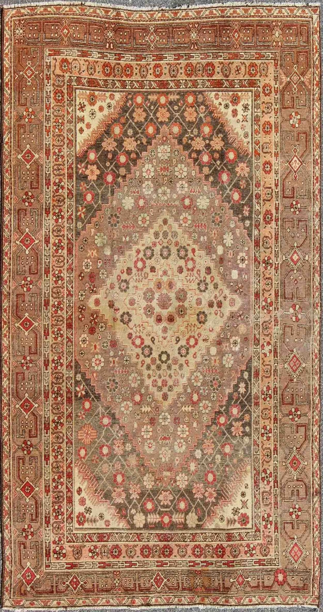 Antique Khotan Medallion Rug in Neutrals and Blush with Floral Motifs All - Over Measures: 6'4 x 11'6 This beautiful Khotan rug, from early 20th century Turkestan features layered medallions in geometric and diamond shapes. The field and ... - Keivan Woven ArtsMP - 252 - 2125Rug