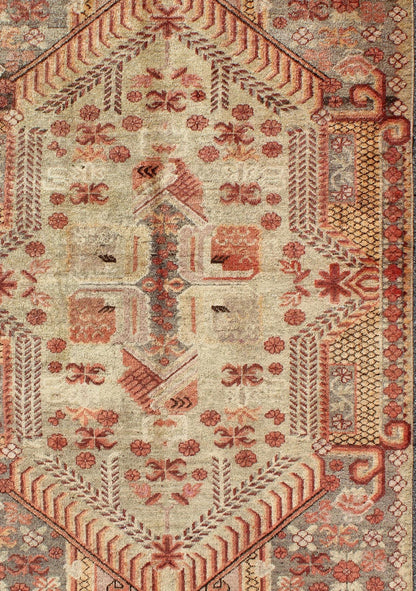 Antique Khotan Rug with Unique Pattern in Gray Border, soft Yellow Green field, Red, Red Orange, Lt. Green & Brown. Khotan Antique Rug with Exquisite Tribal Patterns in Gray, Light blue, Orange, Lt. Green, Orange, Sand, Taupe. Keivan Woven Arts... - Keivan Woven ArtsMP - 884 - 113550 - 3025Rug
