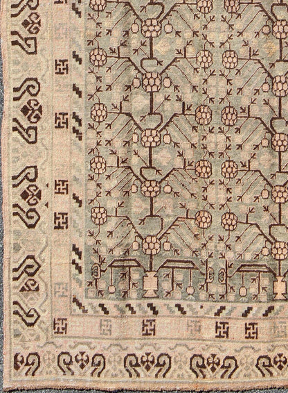 Antique Turkmenistan Khotan Carpet This wonderful Khotan shows the traditional pomegranate design with a unique color combination. The border has a scroll design, with a smaller Greek key guard border. The beautiful colors include a gray - blue ba... - Keivan Woven ArtsMP - 885 - 375 - 3031Rug