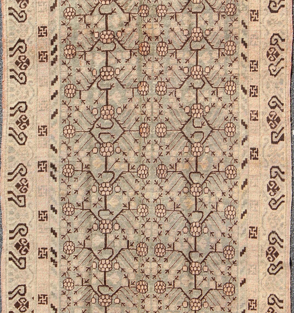 Antique Turkmenistan Khotan Carpet This wonderful Khotan shows the traditional pomegranate design with a unique color combination. The border has a scroll design, with a smaller Greek key guard border. The beautiful colors include a gray - blue ba... - Keivan Woven ArtsMP - 885 - 375 - 3031Rug