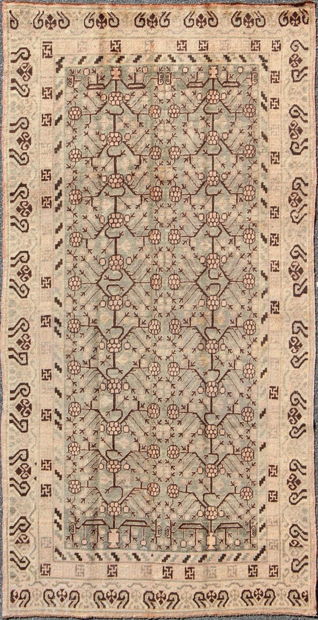 Antique Turkmenistan Khotan Carpet This wonderful Khotan shows the traditional pomegranate design with a unique color combination. The border has a scroll design, with a smaller Greek key guard border. The beautiful colors include a gray - blue ba... - Keivan Woven ArtsMP - 885 - 375 - 3031Rug