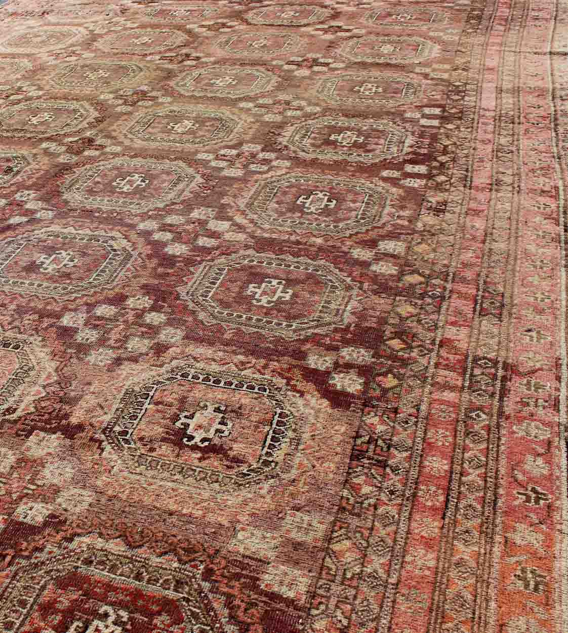 Antique Khotan rug with repeating medallion design in maroon / red, mpc - 538, country of origin / type: Russia / tribal, circa 1900 This piece is a rare antique carpet from Turkestan with delightful colors and all - over repeating medallion design.... - Keivan Woven ArtsMPC - 538 - 8988Rug
