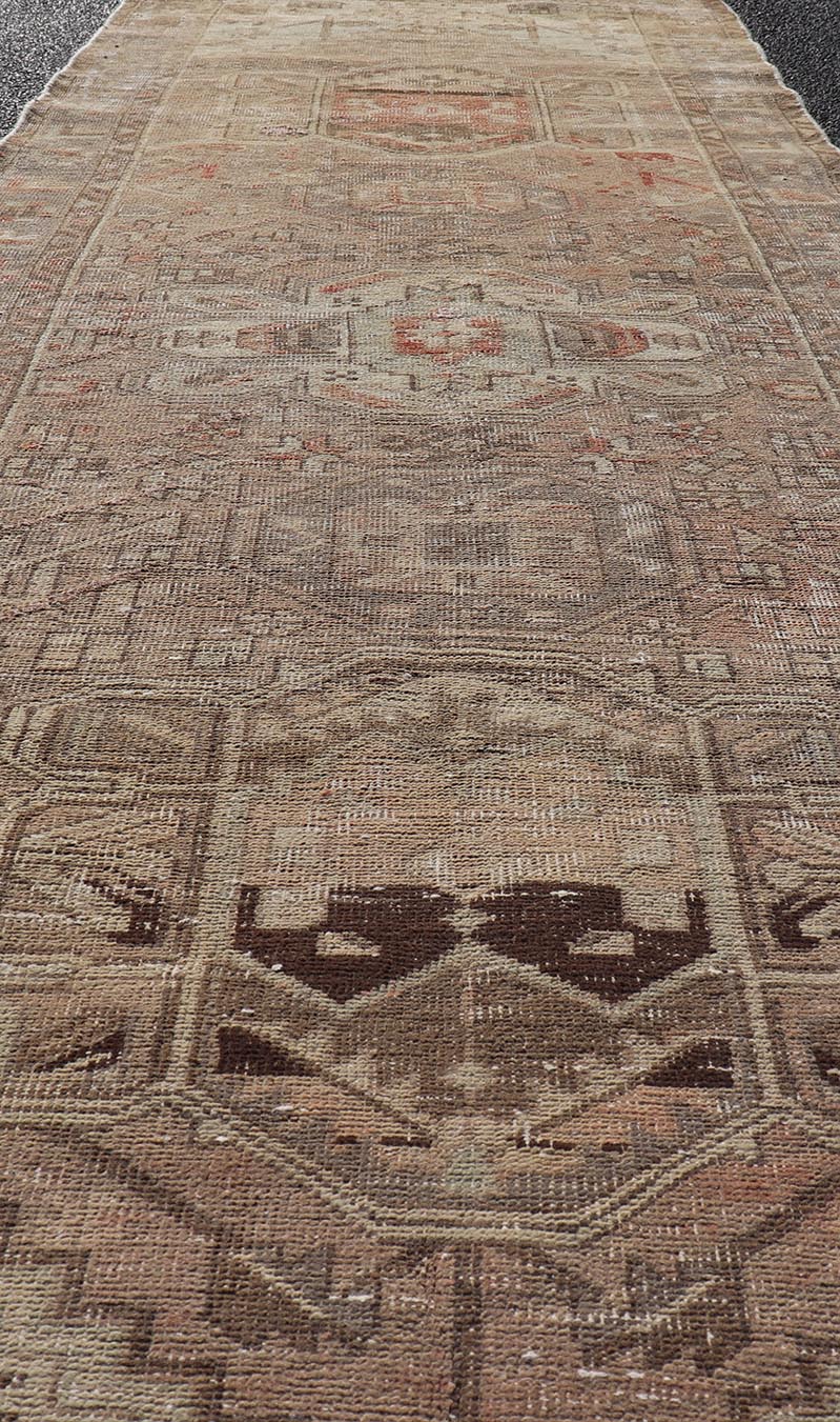 Vintage Persian Heriz by Keivan Woven Arts Distressed Runner in Earthy Tones With Medallion Design. Keivan Woven Arts / rug MSE - 1229, country of origin / type: Iran / Heriz, circa 1960. Measures: 3'4 x 10'4 This vintage Persian Heriz carpet fea... - Keivan Woven ArtsMSE - 1229 - 25539Rug