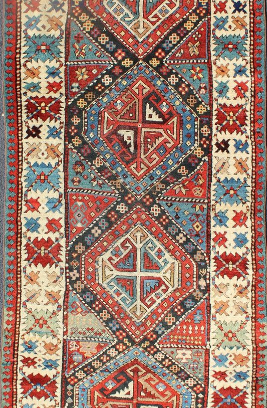 Antique Caucasian Kuba Rug This piece is an impeccable late 19th century Kuba rug with an indigo blue field beneath a geometric vinery trellis featuring bold polychrome medallions and stylized leaves. The ivory frame features repeating turtle mo... - Keivan Woven ArtsN15 - 0308 - 18Rug