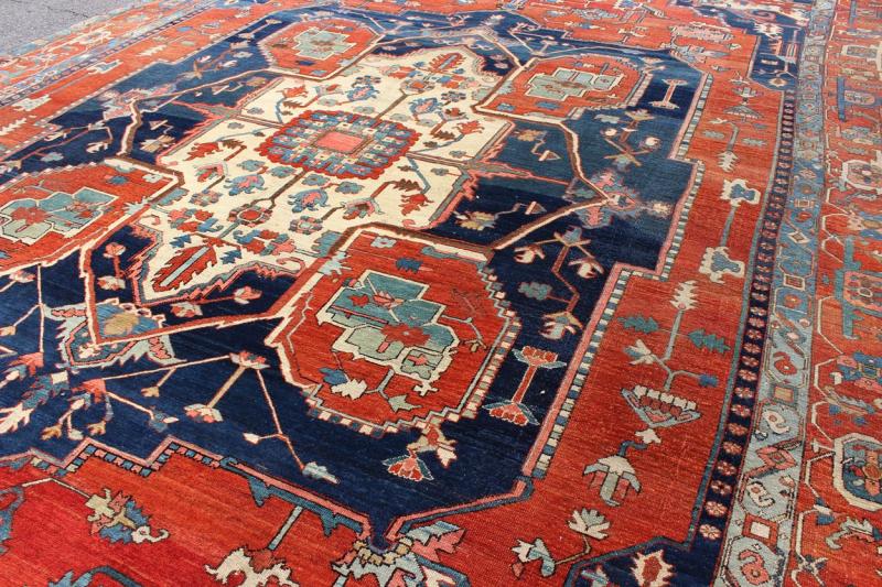 Antique Persian fine weave Serapi rug with large geometric medallion in brilliant colors and blue and tomato red. Keivan Woven Arts / Rug / N15 - 1204 / country of origin / type: Iran /Serapi, circa 1900. Measures: 10.3 x 14.4. Antique Serapi rugs... - Keivan Woven ArtsN15 - 1204 - 7889Rug