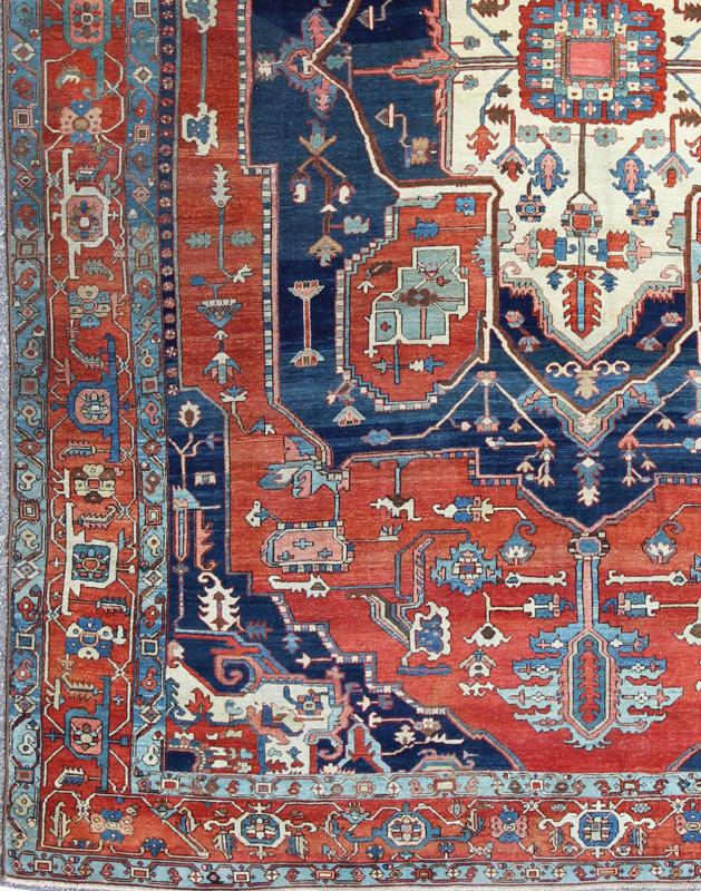 Antique Persian fine weave Serapi rug with large geometric medallion in brilliant colors and blue and tomato red. Keivan Woven Arts / Rug / N15 - 1204 / country of origin / type: Iran /Serapi, circa 1900. Measures: 10.3 x 14.4. Antique Serapi rugs... - Keivan Woven ArtsN15 - 1204 - 7889Rug