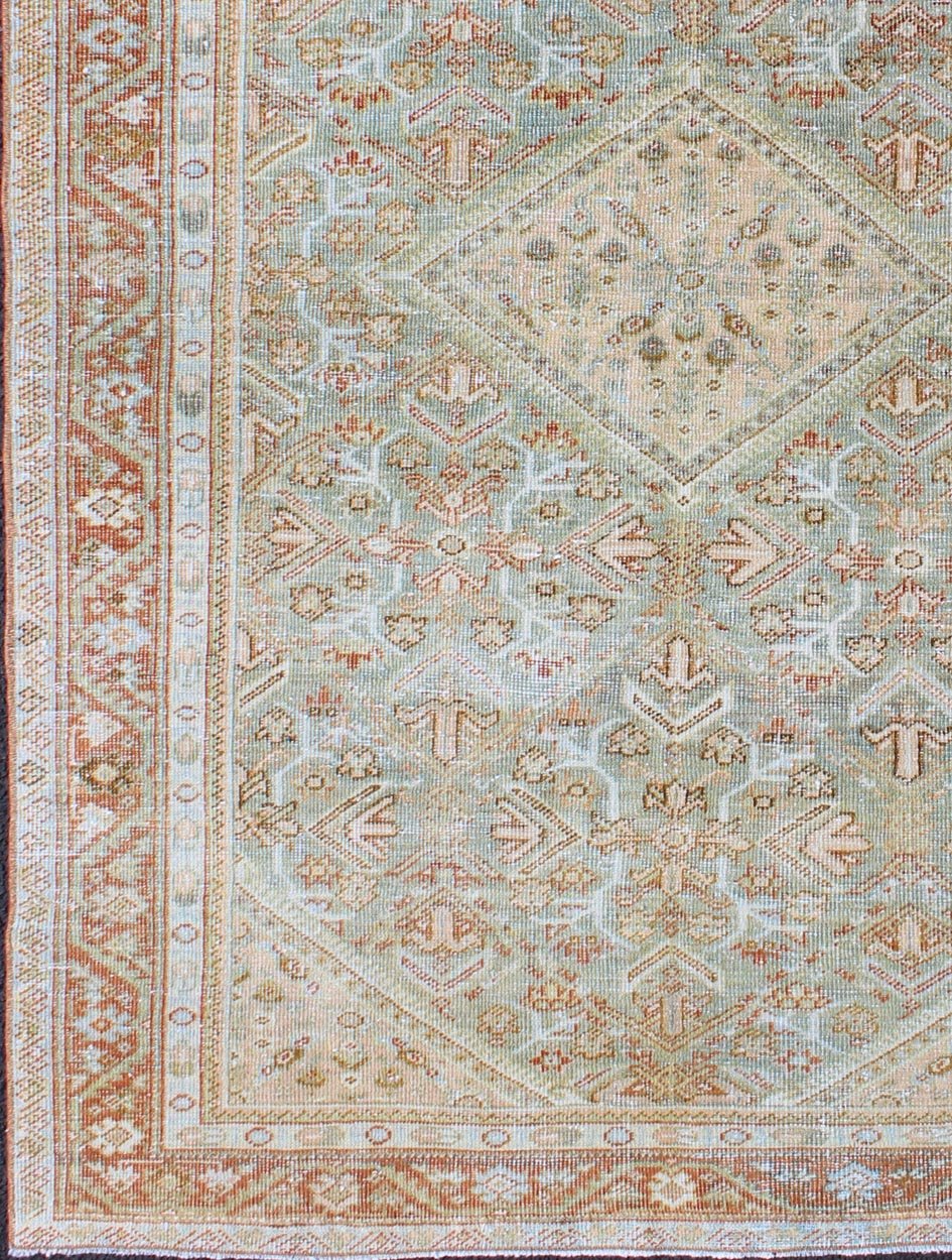 Persian Mahal antique rug with floral design in Peach, green, blue, and red colors with central Medallion, rug na - 180709, country of origin / type: Iran / Mahal, circa 1920. This antique Persian Mahal rug, circa early 20th century, relies heavil... - Keivan Woven ArtsNA - 180709 - 10512Rug