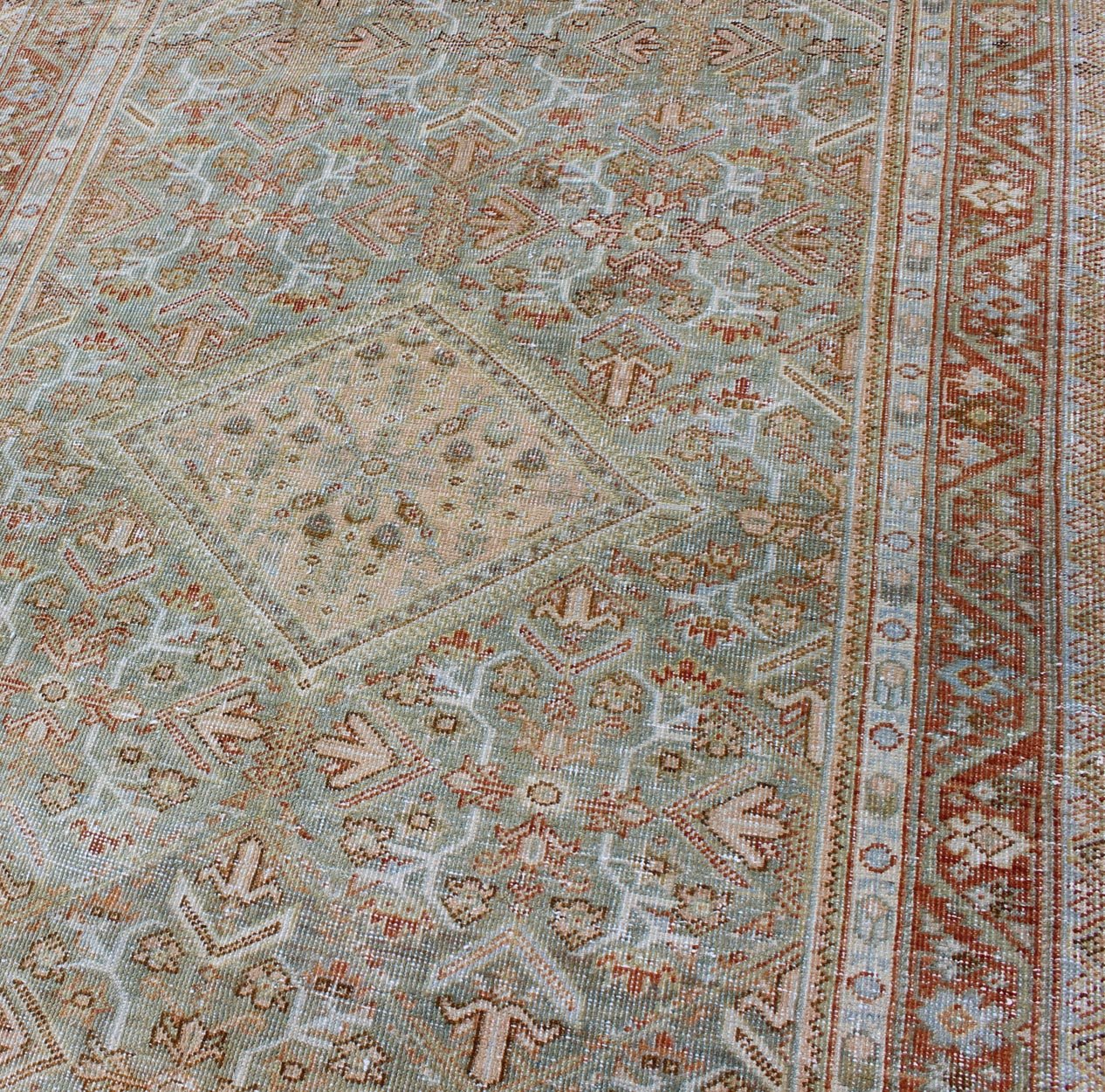 Persian Mahal antique rug with floral design in Peach, green, blue, and red colors with central Medallion, rug na - 180709, country of origin / type: Iran / Mahal, circa 1920. This antique Persian Mahal rug, circa early 20th century, relies heavil... - Keivan Woven ArtsNA - 180709 - 10512Rug