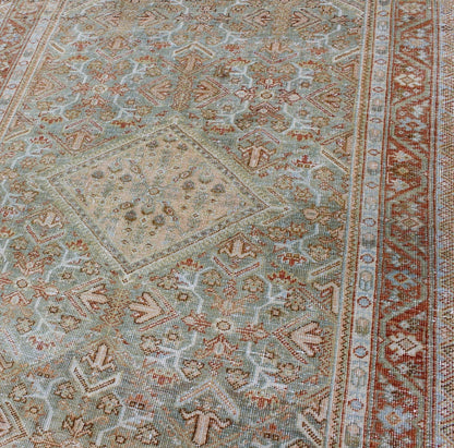 Persian Mahal antique rug with floral design in Peach, green, blue, and red colors with central Medallion, rug na - 180709, country of origin / type: Iran / Mahal, circa 1920. This antique Persian Mahal rug, circa early 20th century, relies heavil... - Keivan Woven ArtsNA - 180709 - 10512Rug