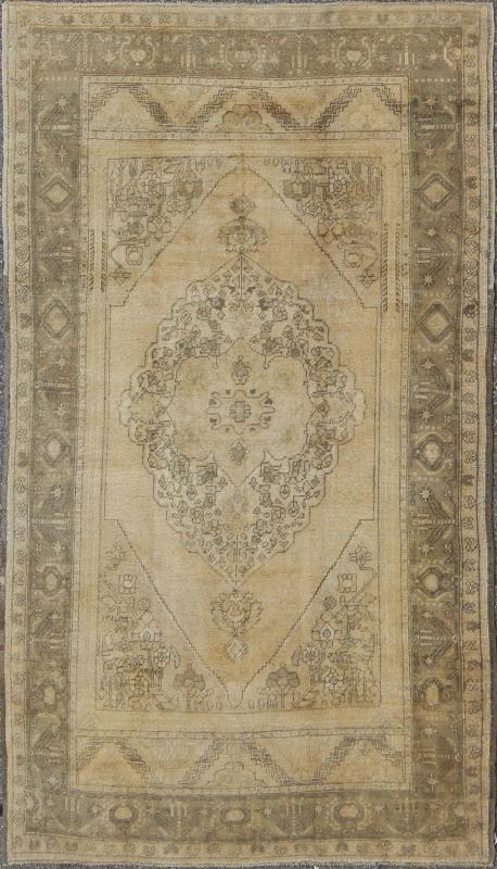 Antique Turkish Oushak with Stylized Medallion Design in Muted Neutral Tones This beautifully muted antique Turkish Oushak displays a stretched central medallion filled with Sub - geometric floral motifs and capped with palmettes. The saw - toothed ... - Keivan Woven ArtsNA - 54726 - 1582Rug