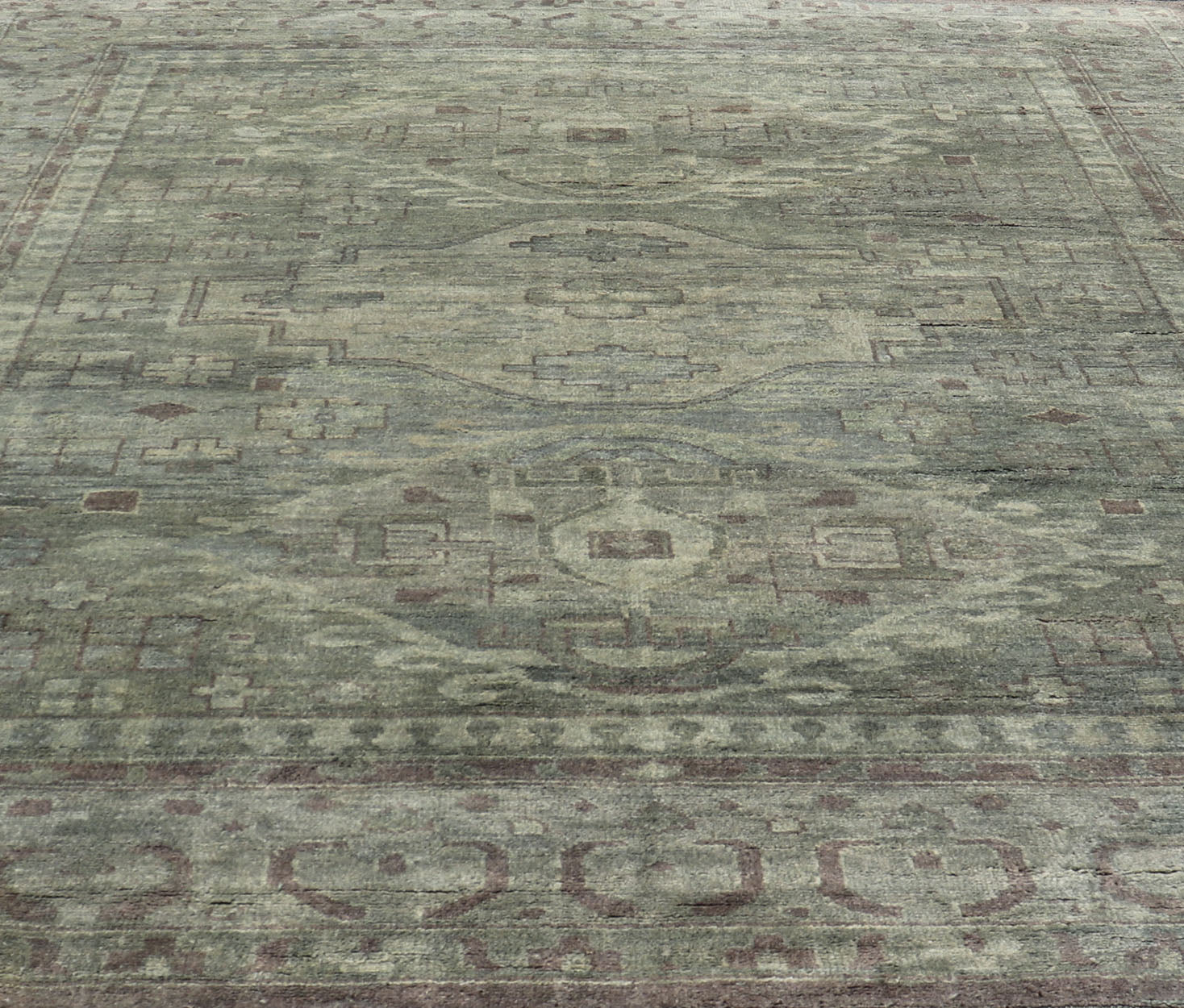 Large Modern Tribal Medallion Khotan in Muted Earthy Green Colors Measures 12'0 x 15'0 The border has tribal markings in a rich green brown color, atop a rustic blend of forest green background. The field remains the same forest green c... - Keivan Woven ArtsOB - 103434781 - 6230017 - 21084Rug