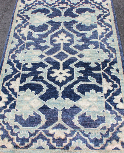 Modern Hand - Knotted Oushak Rug in Wool with Sub - Geometric Design in Blue This modern Indian Oushak rug has been hand - knotted in wool and features an all - over, sub - geometric design rendered in blue and ivory tones. A complementary, multi - tiered ... - Keivan Woven ArtsOB - 10542973 - 6230320 - 11311Rug