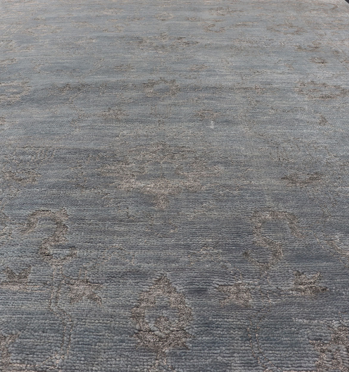 Modern Hand - Knotted Rug in Wool with Floral Design in Blue and Gray This modern Indian rug has been hand - knotted in wool and features an all - over, sub - geometric floral design rendered in blue and gray tones. A complementary, multi - tiered border ... - Keivan Woven ArtsOB - 105860644 - 17346Rug