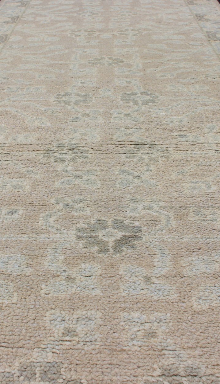 Modern Khotan Runner in Wool with All - Over Sub - Geometric Floral Design This modern Indian Khotan rug has been hand - knotted in wool and features an all - over, sub - geometric floral design rendered in blue and neutral tones. A complementary border e... - Keivan Woven ArtsOB - 9289470 - 6270004 - 11332Rug