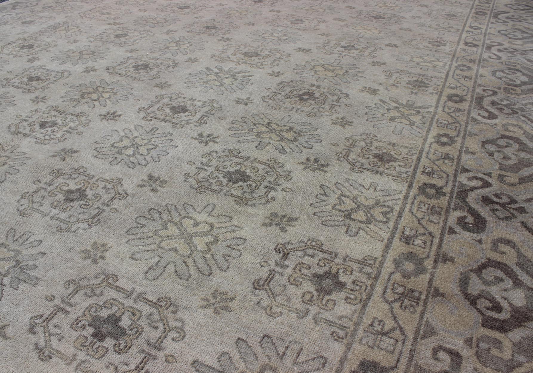 Keivan Woven Arts Hand Knotted Khotan Wool Rug With Sub - Geometric Design. This contemporary Khotan rug has been hand - knotted in wool and features a sub - geometric design rendered in tan and taupe colors. A complementary, multi - tiered border enc... - Keivan Woven ArtsOB - 9299796 - 592009 - 8519Rug