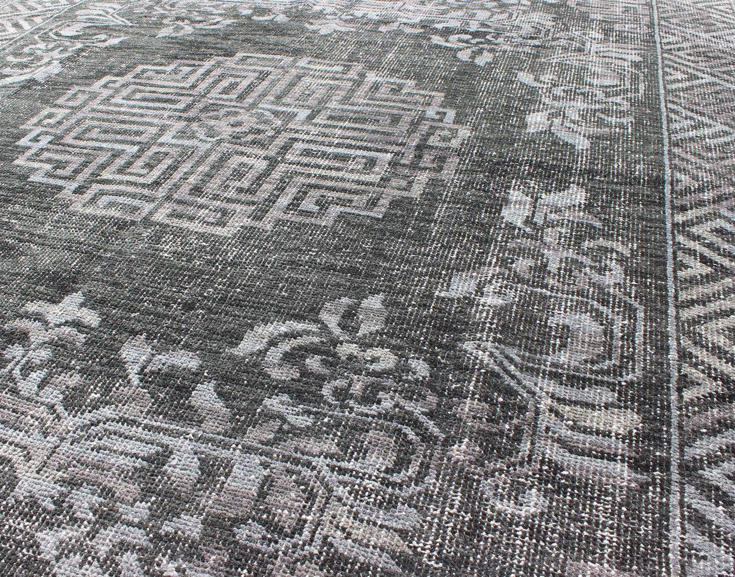 Keivan Woven Arts Modern Khotan Hand Knotted Wool Rug in Charcoal & Gray. This modern Khotan rug has been hand - knotted features an all - over, sub - geometric late central medallion design rendered in charcoal and gray tones. A complementary border encompa... - Keivan Woven ArtsOB - 9444206 - 56230109 - 9308Rug