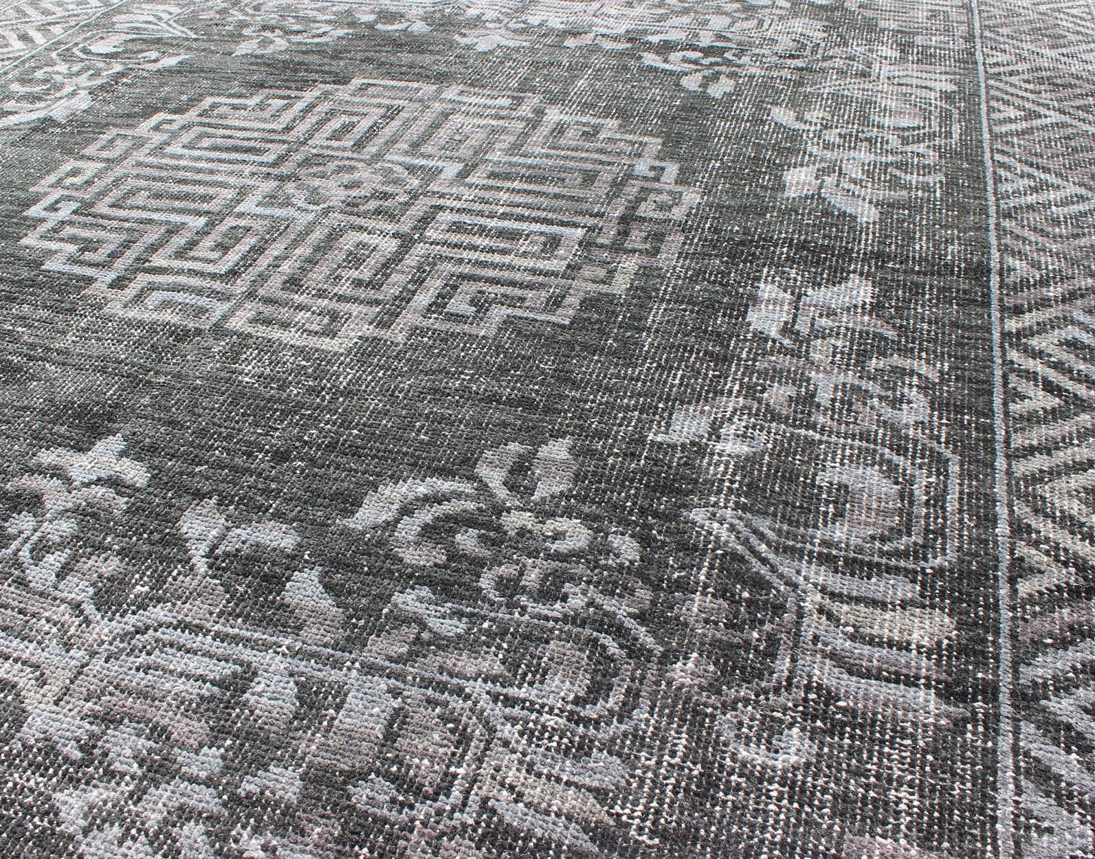 Keivan Woven Arts Modern Khotan Hand Knotted Wool Rug in Charcoal & Gray. This modern Khotan rug has been hand - knotted features an all - over, sub - geometric late central medallion design rendered in charcoal and gray tones. A complementary border encompa... - Keivan Woven ArtsOB - 9444206 - 56230109 - 9308Rug