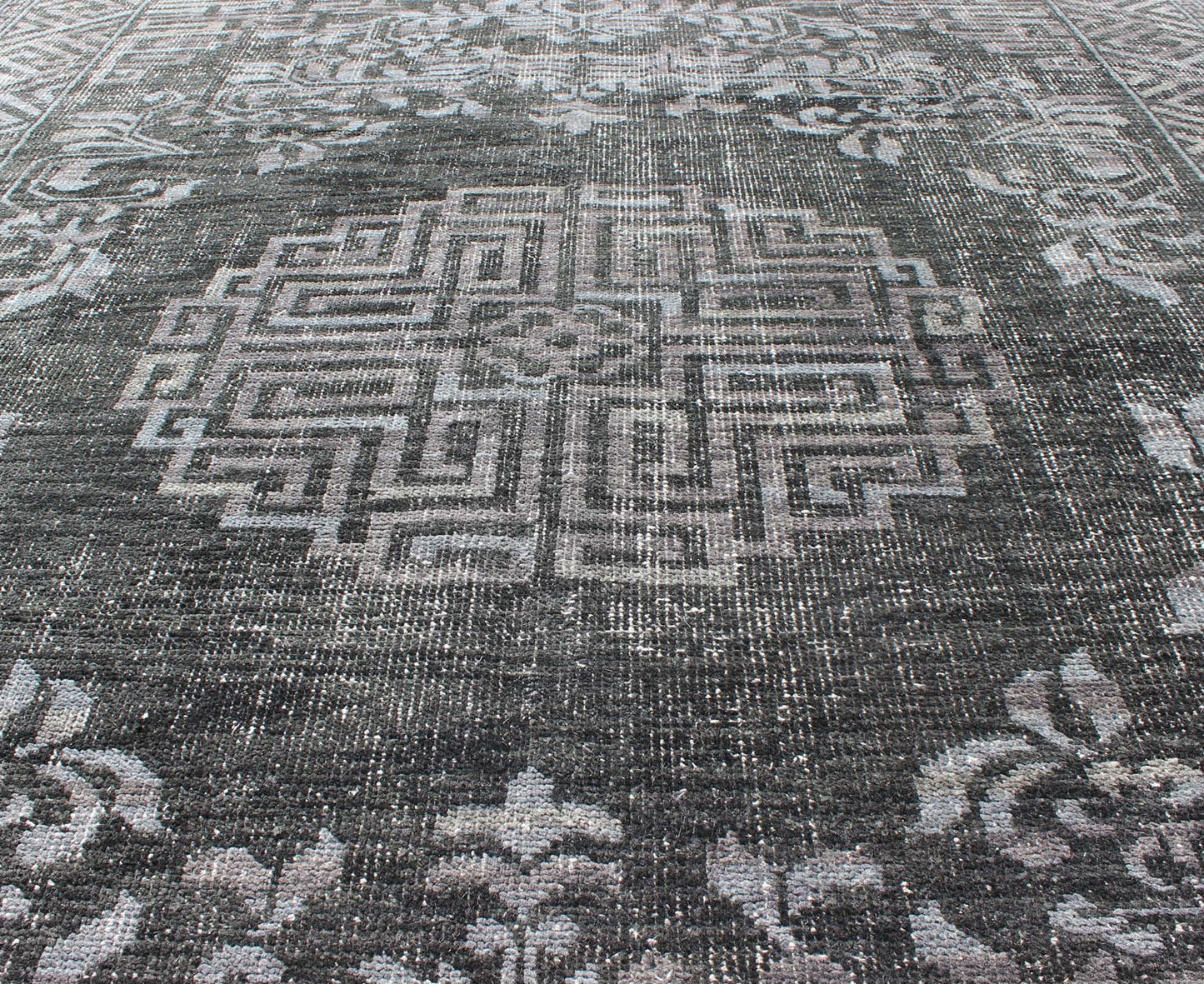 Keivan Woven Arts Modern Khotan Hand Knotted Wool Rug in Charcoal & Gray. This modern Khotan rug has been hand - knotted features an all - over, sub - geometric late central medallion design rendered in charcoal and gray tones. A complementary border encompa... - Keivan Woven ArtsOB - 9444206 - 56230109 - 9308Rug