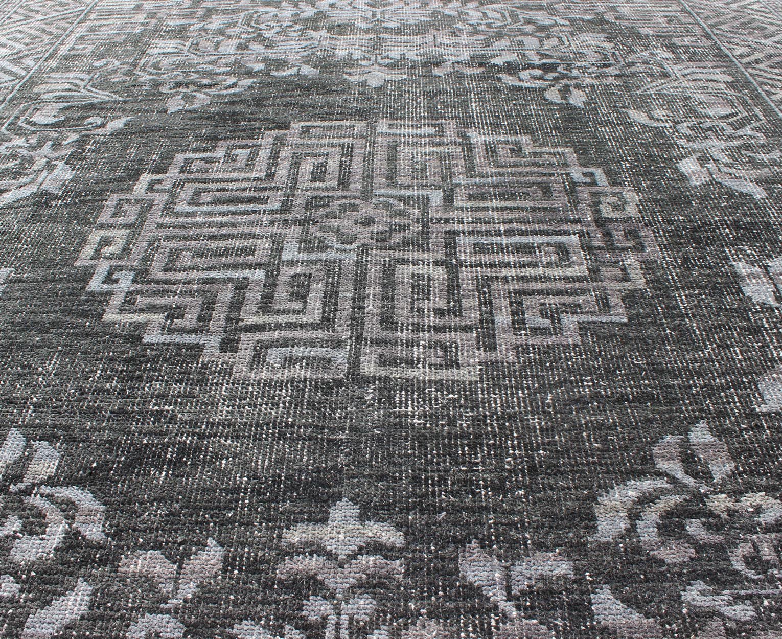 Keivan Woven Arts Modern Khotan Hand Knotted Wool Rug in Charcoal & Gray. This modern Khotan rug has been hand - knotted features an all - over, sub - geometric late central medallion design rendered in charcoal and gray tones. A complementary border encompa... - Keivan Woven ArtsOB - 9444206 - 56230109 - 9308Rug