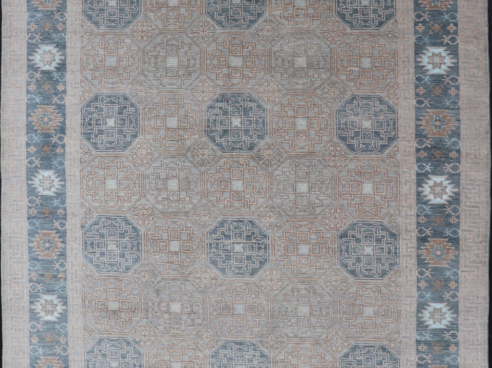 Modern Hand Knotted Khotan in Wool with All - Over Medallion Design in Blue and Earthy Tones This modern Indian Khotan rug has been hand - knotted in wool and features an all - over, sub - geometric medallion design rendered in blue and earthy tones. A ... - Keivan Woven ArtsOB - 9538562 - 98000069 - 15490Rug