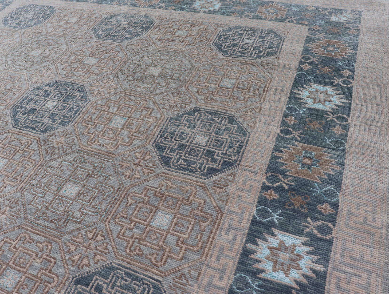 Modern Hand Knotted Khotan in Wool with All - Over Medallion Design in Blue and Earthy Tones This modern Indian Khotan rug has been hand - knotted in wool and features an all - over, sub - geometric medallion design rendered in blue and earthy tones. A ... - Keivan Woven ArtsOB - 9538562 - 98000069 - 15490Rug