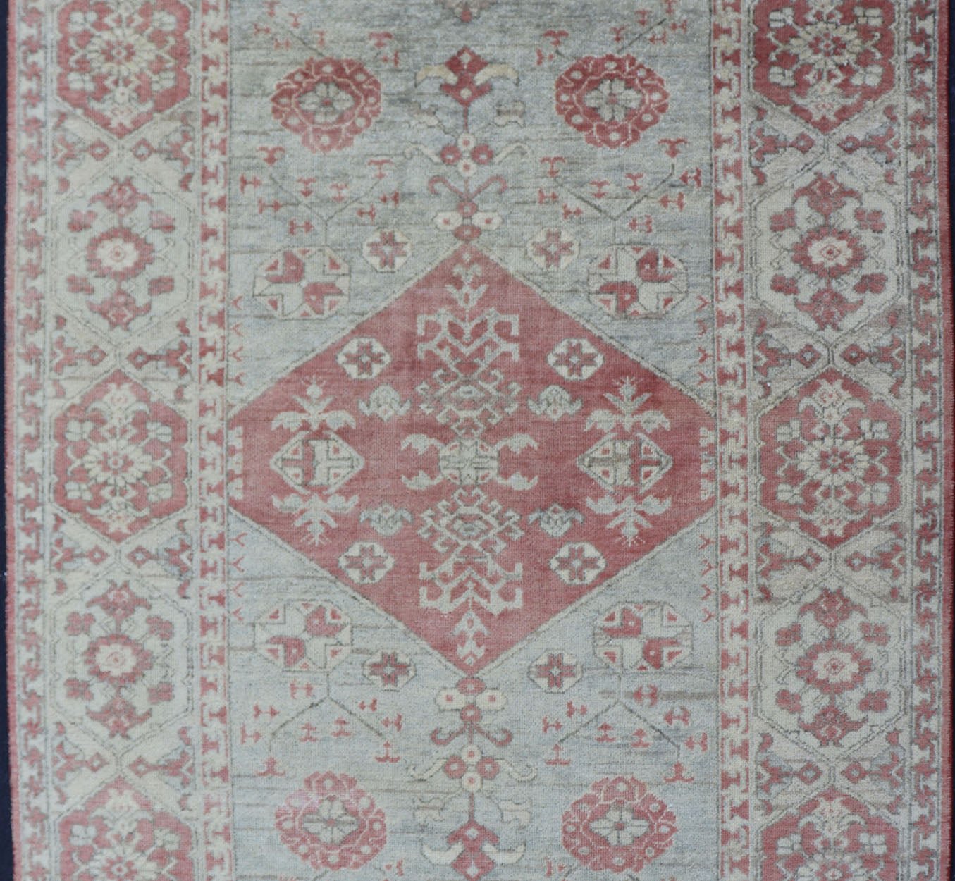 Modern Oushak Rug in Wool with Medallion Design in Light Blue and Coral This modern Indian Khotan rug has been hand - knotted in wool and features a floral medallion design rendered in light blue and coral tones. A complementary, multi - tiered bor... - Keivan Woven ArtsOB - 9580377 - 83230118 - 15502