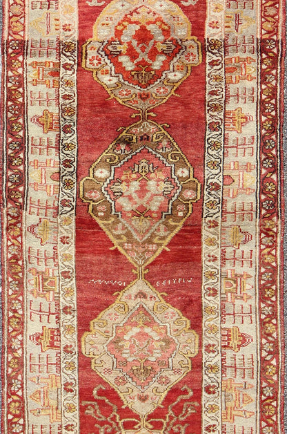 Antique Turkish Oushak Runner In Red Background with Neutral Medallions Measures: 3.11 x 9.0 This colorful Oushak carpet rests beautifully upon a field of elegant red. A large medallion of brown, taupe, yellow and gray takes center s... - Keivan Woven ArtsOSM - 02 - 4494Rug