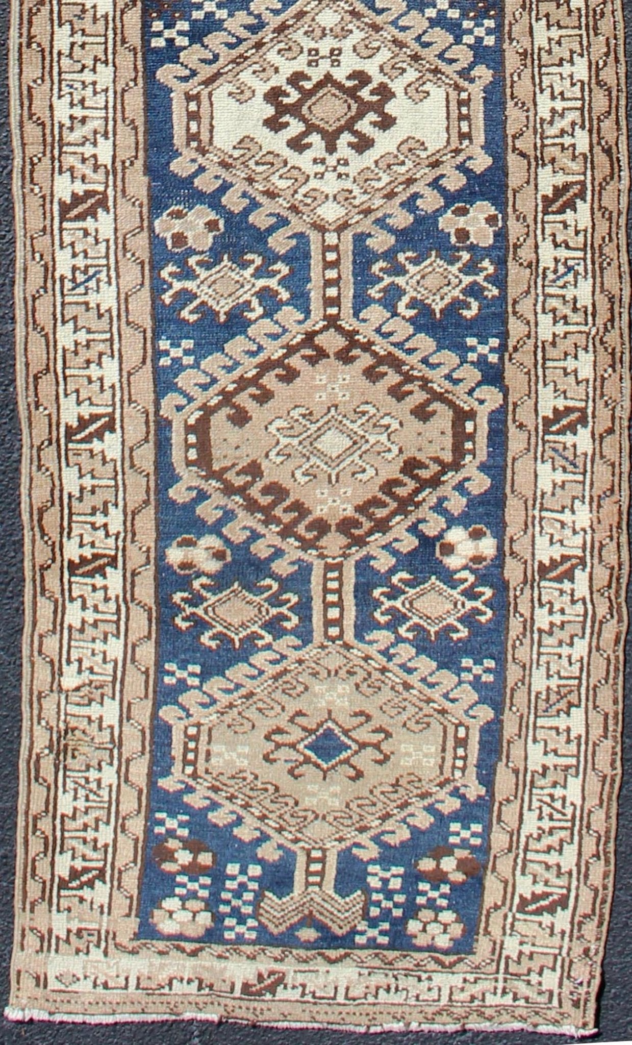 Antique Blue Tribal Karajeh Runner With Navy Blue, Brown and Earth Tones. Antique Persian Karajeh runner with stacked medallion in taupe, cream, blue, rug PRM - M522, country of origin / type: Iran / Karajeh , circa 1920 This antique Persian k... - Keivan Woven ArtsPRM - M522 - 12609
