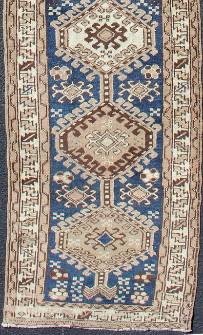 Antique Blue Tribal Karajeh Runner With Navy Blue, Brown and Earth Tones. Antique Persian Karajeh runner with stacked medallion in taupe, cream, blue, rug PRM - M522, country of origin / type: Iran / Karajeh , circa 1920 This antique Persian k... - Keivan Woven ArtsPRM - M522 - 12609Rug