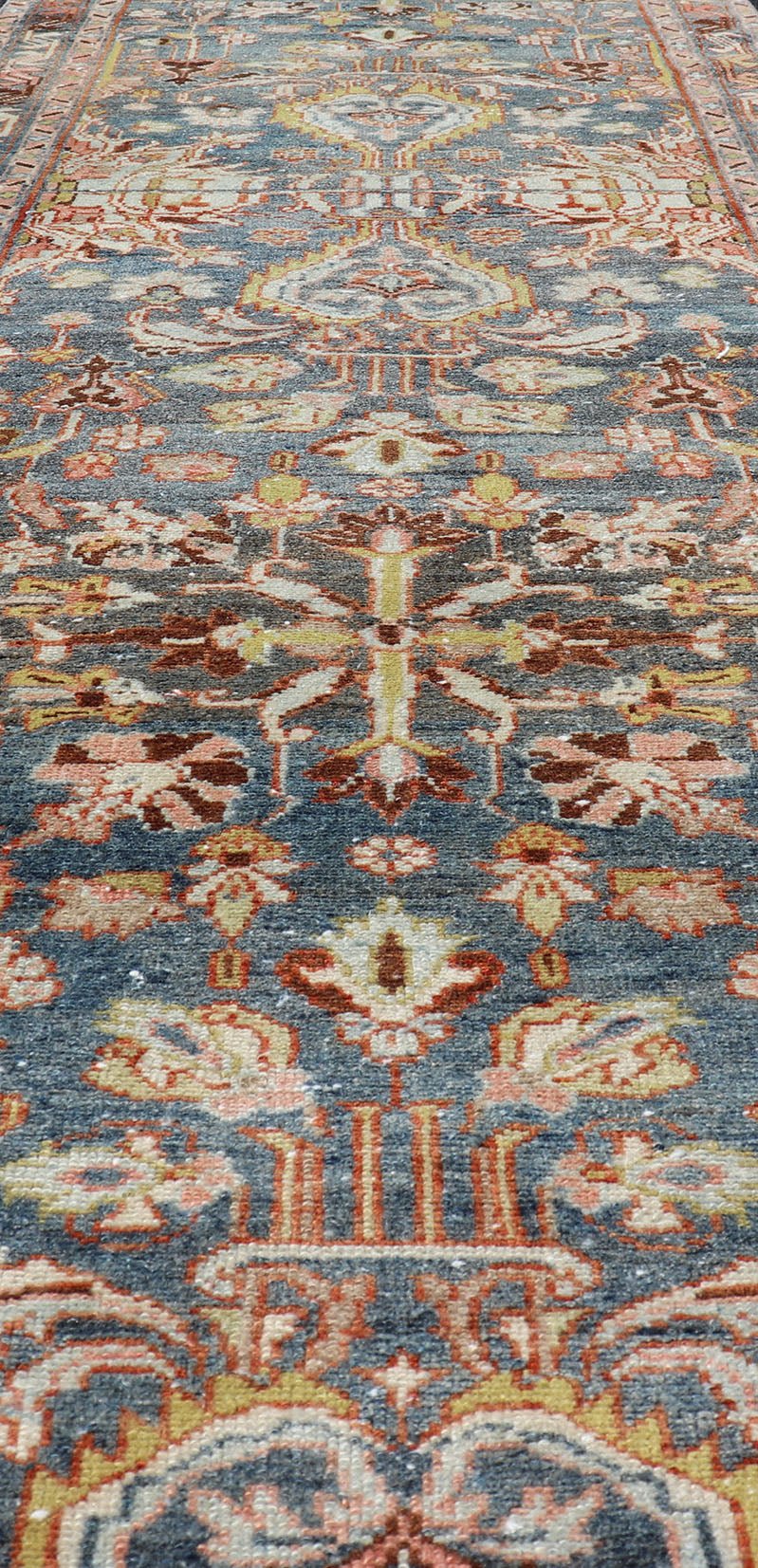 Antique Persian Malayer Runner All - Over Floral Design on A Blue Background This antique Persian Malayer runner is rendered in rich colors, from the blue background to the pink, coral, light yellow, brown, and light blue shown in the design... - Keivan Woven ArtsPTA - 21004 - 18084Rug