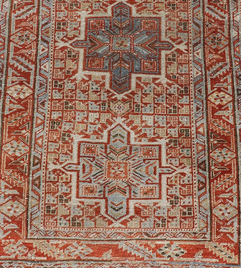 Vintage Persian Distressed Heriz Runner in Wool with Tribal Medallions This antique Persian Heriz rug features a distressed all - over sub - geometric design rendered in soft red as well as light blue tones, and is set upon an ivory background. A co... - Keivan Woven ArtsPTA - 21008 - 18090