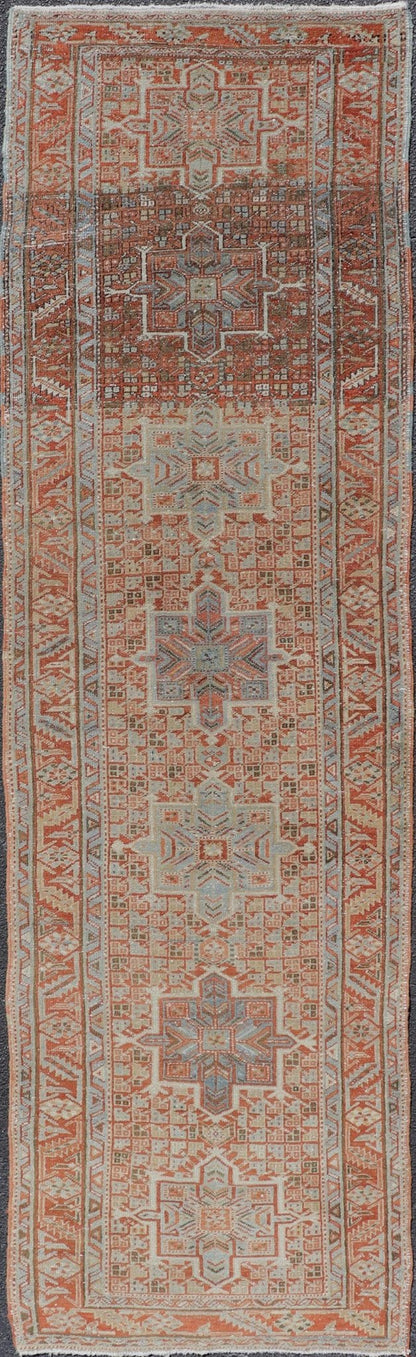 Vintage Persian Distressed Heriz Runner in Wool with Tribal Medallions This antique Persian Heriz rug features a distressed all - over sub - geometric design rendered in soft red as well as light blue tones, and is set upon an ivory background. A co... - Keivan Woven ArtsPTA - 21008 - 18090