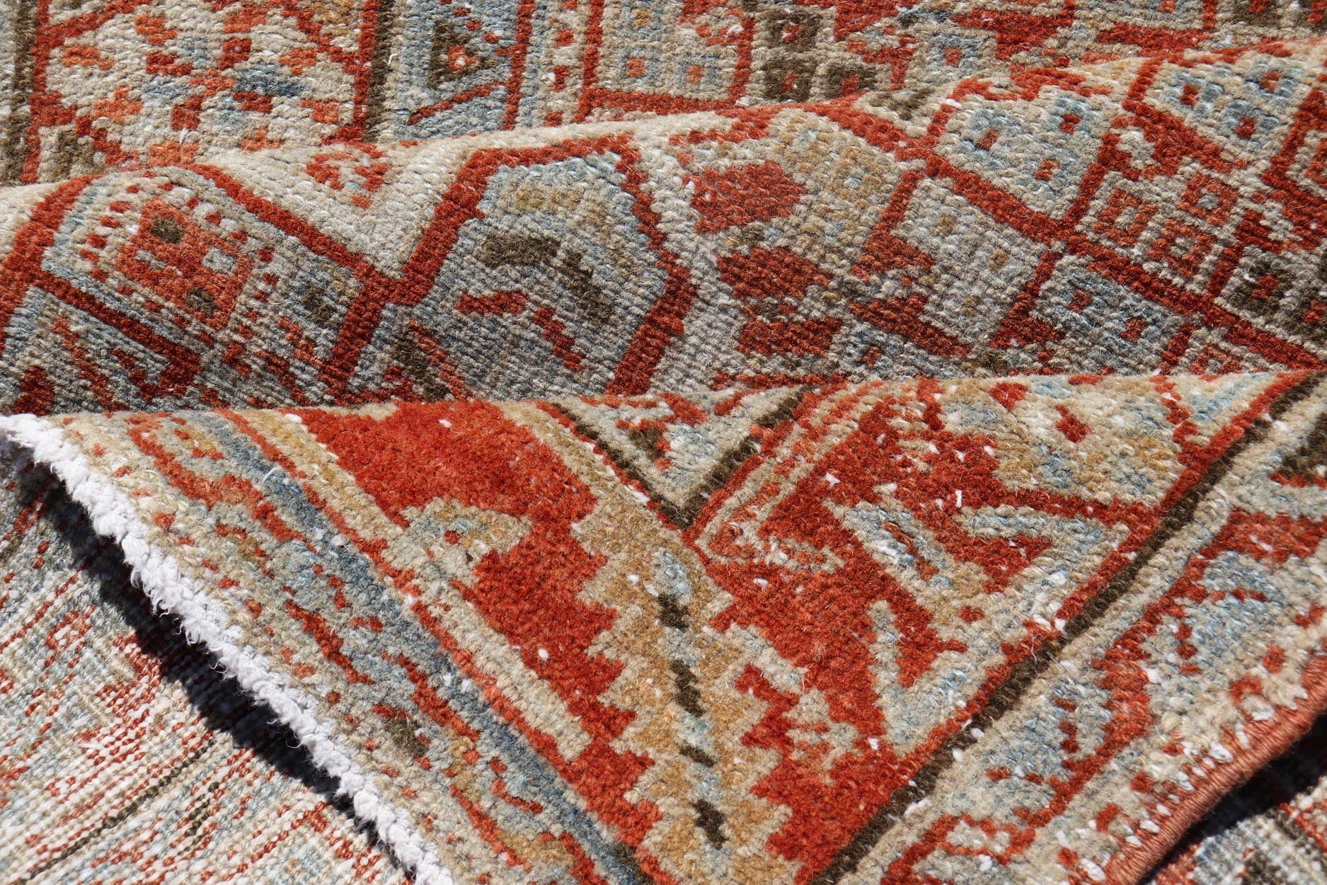 Vintage Persian Distressed Heriz Runner in Wool with Tribal Medallions This antique Persian Heriz rug features a distressed all - over sub - geometric design rendered in soft red as well as light blue tones, and is set upon an ivory background. A co... - Keivan Woven ArtsPTA - 21008 - 18090