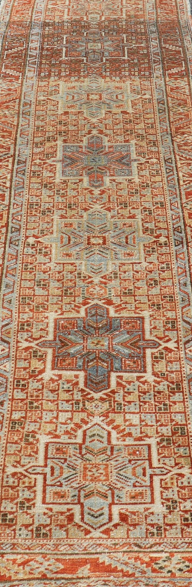 Vintage Persian Distressed Heriz Runner in Wool with Tribal Medallions This antique Persian Heriz rug features a distressed all - over sub - geometric design rendered in soft red as well as light blue tones, and is set upon an ivory background. A co... - Keivan Woven ArtsPTA - 21008 - 18090