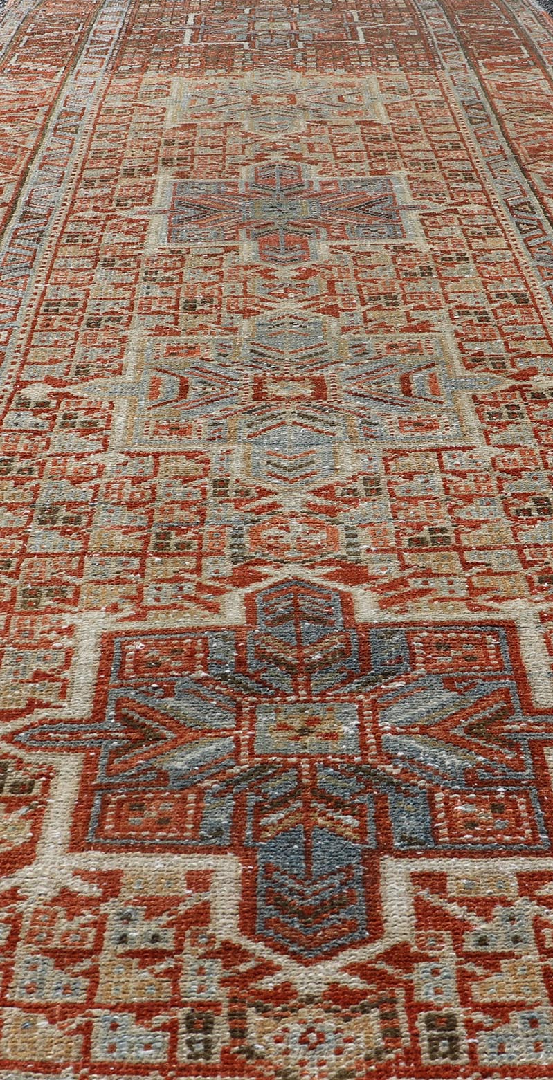 Vintage Persian Distressed Heriz Runner in Wool with Tribal Medallions This antique Persian Heriz rug features a distressed all - over sub - geometric design rendered in soft red as well as light blue tones, and is set upon an ivory background. A co... - Keivan Woven ArtsPTA - 21008 - 18090