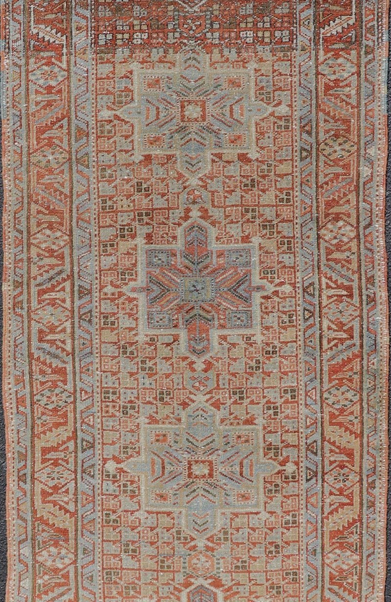 Vintage Persian Distressed Heriz Runner in Wool with Tribal Medallions This antique Persian Heriz rug features a distressed all - over sub - geometric design rendered in soft red as well as light blue tones, and is set upon an ivory background. A co... - Keivan Woven ArtsPTA - 21008 - 18090