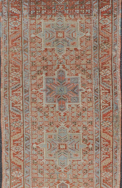 Vintage Persian Distressed Heriz Runner in Wool with Tribal Medallions This antique Persian Heriz rug features a distressed all - over sub - geometric design rendered in soft red as well as light blue tones, and is set upon an ivory background. A co... - Keivan Woven ArtsPTA - 21008 - 18090