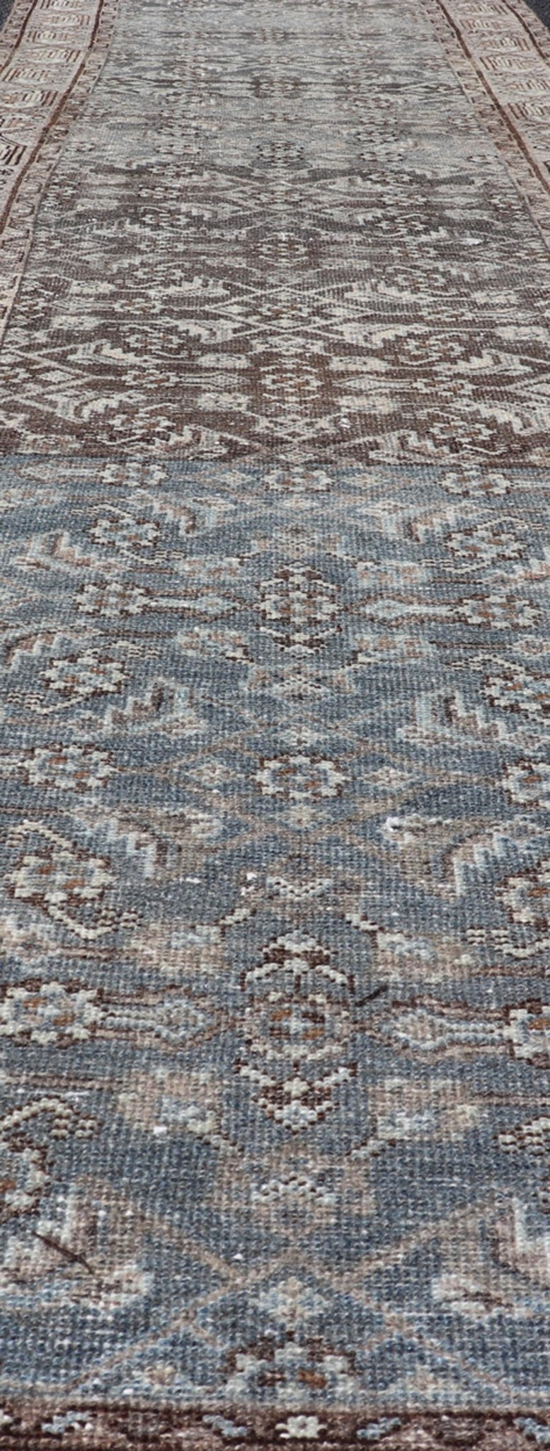 Antique Hand - Knotted Persian Hamadan Runner in Wool with All - Over Floral Design This antique Persian Hamadan rug has been hand - knotted in wool and features an all - over sub - geometric design rendered in multicolor. A complementary, multi - tiered b... - Keivan Woven ArtsPTA - 21011 - 18096