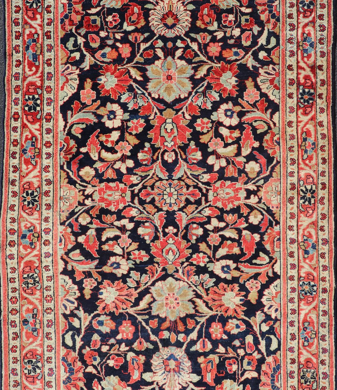 Antique Persian Gallery Runner with Floral Design in D. Blue & Jewel Tones. This lovely antique Gallery Mahal features a stunning all - over floral design set upon a dark blue background, and rendered in Ivory, Coral, varieties of Reds, Greens an... - Keivan Woven ArtsPTA - 21019 - 17376Rug