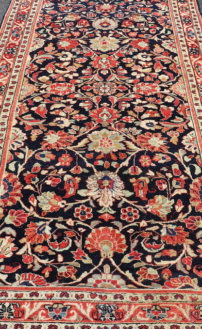 Antique Persian Gallery Runner with Floral Design in D. Blue & Jewel Tones. This lovely antique Gallery Mahal features a stunning all - over floral design set upon a dark blue background, and rendered in Ivory, Coral, varieties of Reds, Greens an... - Keivan Woven ArtsPTA - 21019 - 17376Rug