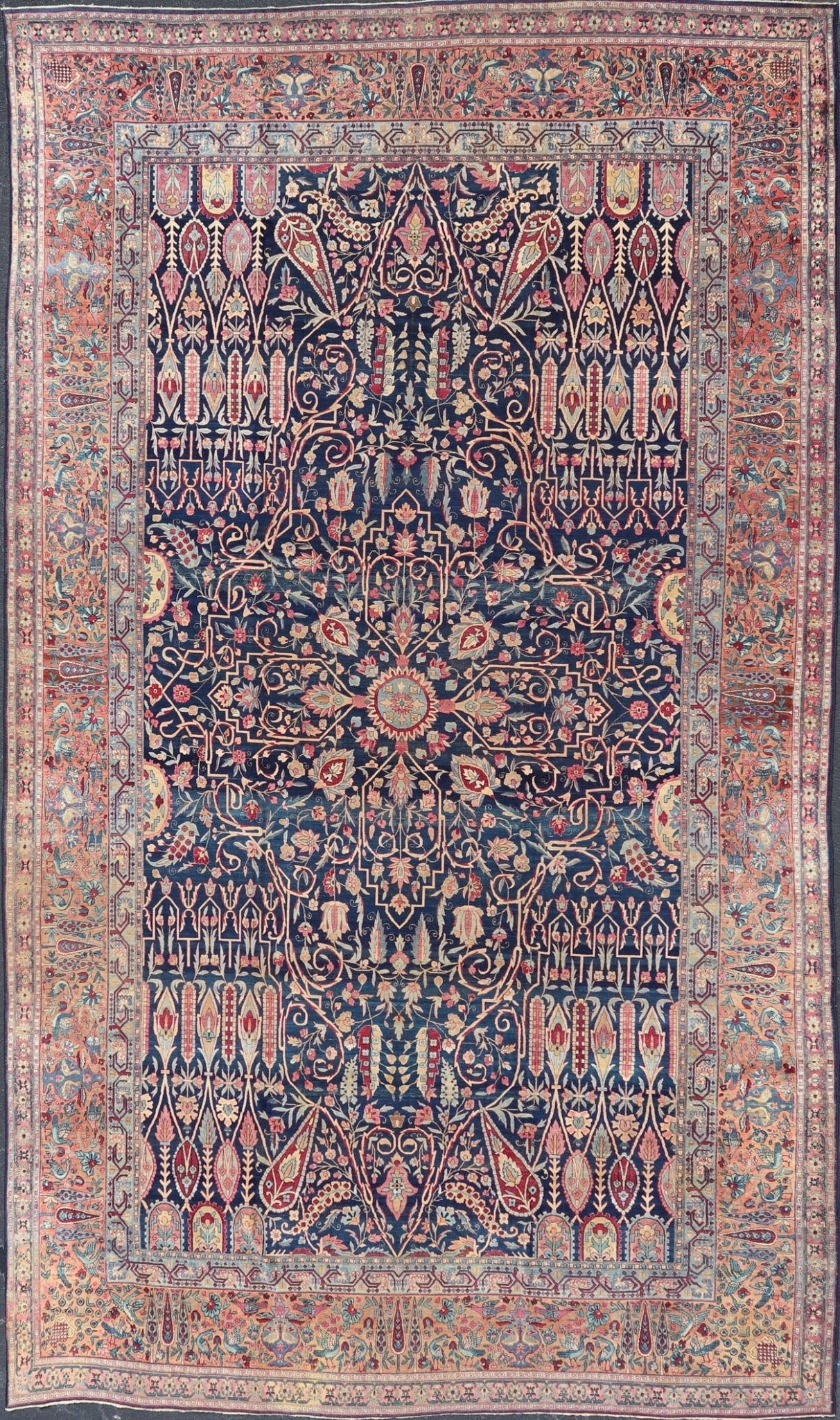Antique Lavar Kerman Persian Rug with All - Over Floral Design on A Blue Field Measures: 11'7 x 19'2 This magnificent antique Lavar Kerman rug features an exquisite all - over floral design, enclosed within a complementary multi - tiered borde... - Keivan Woven ArtsPTA - 2109 - 11 - 17298