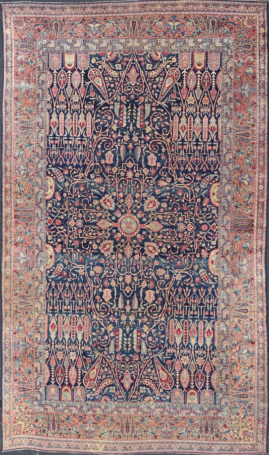 Antique Lavar Kerman Persian Rug with All - Over Floral Design on A Blue Field Measures: 11'7 x 19'2 This magnificent antique Lavar Kerman rug features an exquisite all - over floral design, enclosed within a complementary multi - tiered borde... - Keivan Woven ArtsPTA - 2109 - 11 - 17298