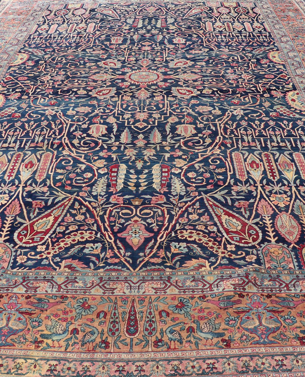 Antique Lavar Kerman Persian Rug with All - Over Floral Design on A Blue Field Measures: 11'7 x 19'2 This magnificent antique Lavar Kerman rug features an exquisite all - over floral design, enclosed within a complementary multi - tiered borde... - Keivan Woven ArtsPTA - 2109 - 11 - 17298
