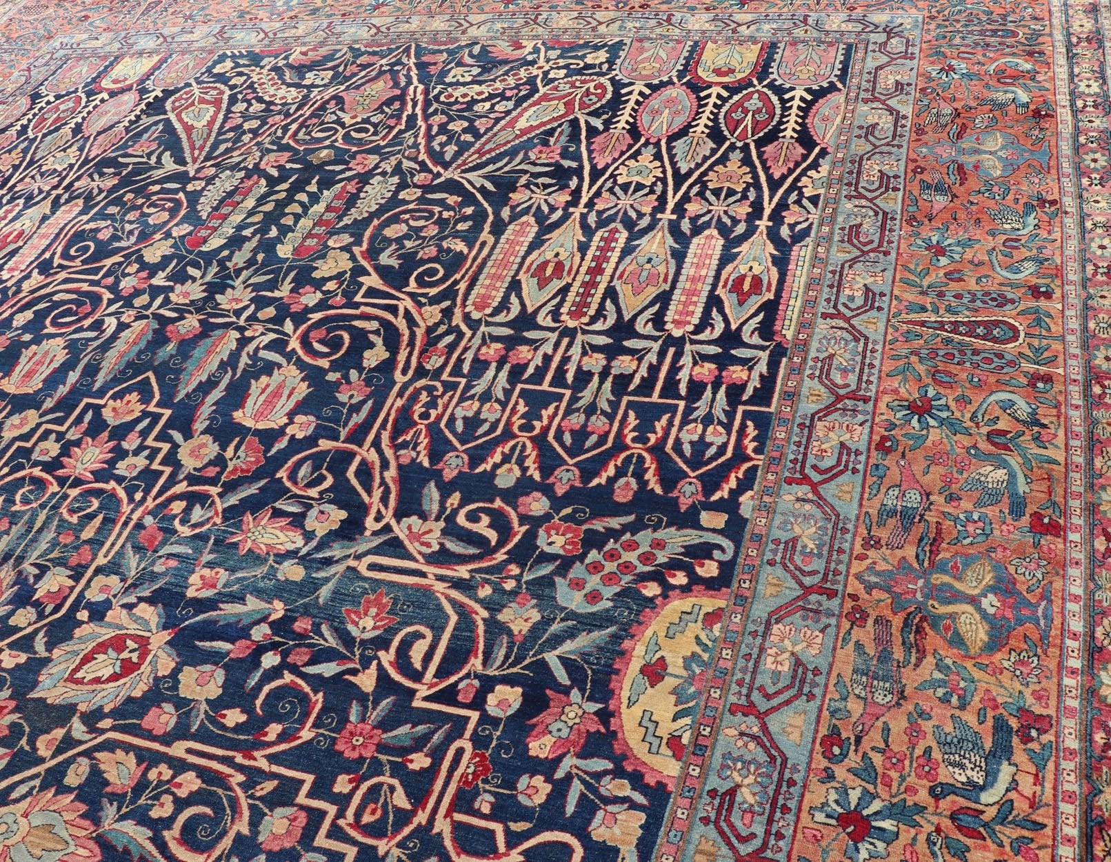 Antique Lavar Kerman Persian Rug with All - Over Floral Design on A Blue Field Measures: 11'7 x 19'2 This magnificent antique Lavar Kerman rug features an exquisite all - over floral design, enclosed within a complementary multi - tiered borde... - Keivan Woven ArtsPTA - 2109 - 11 - 17298